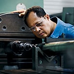 Engineer checking lathe machine