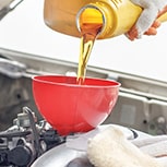 pouring oil into a funnel