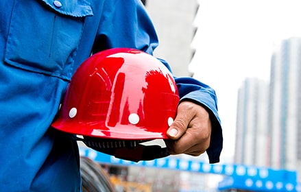 red hardhat in hand